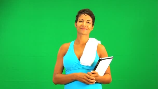 Etniska kvinnliga trådlös tablet fitness grön skärm — Stockvideo