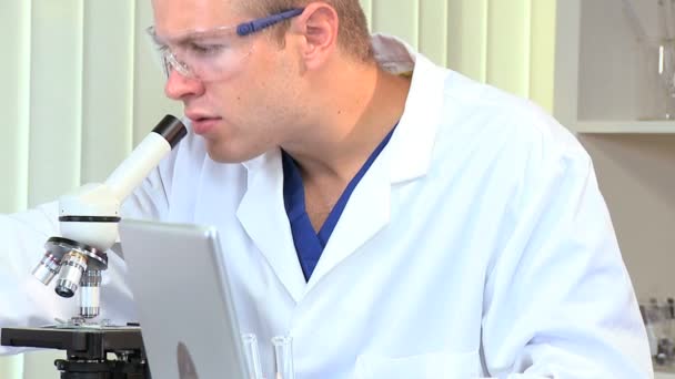 Male Student Researcher with Microscope in Hospital Lab — Stock Video