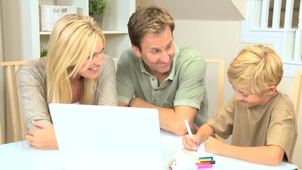 Genitori Guardando figlio con computer portatile e penne a colori — Video Stock