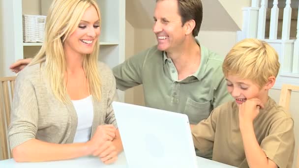 Young Caucasian Boy Using Laptop with Parents — Stock Video