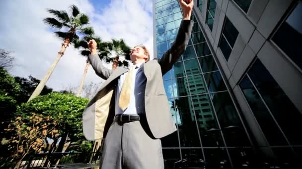 Businessman Triumphant Outside City Buildings — Stock Video