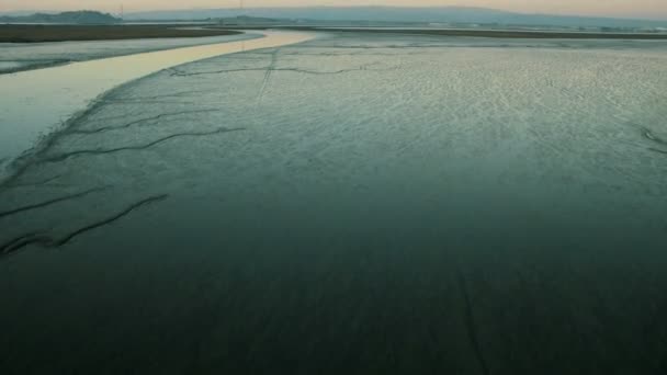 Aerial low angle view of shallow artificial salt ponds — Stock Video