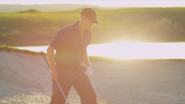 Golfer climbing out of golf course — Stock Video