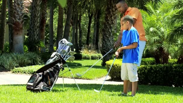 Father teaching son playing golf — Stock Video