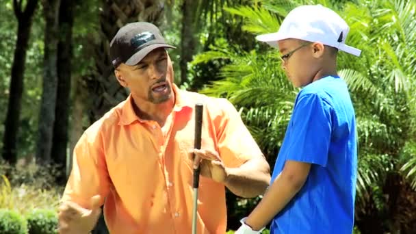 Father teaching son playing golf — Stock Video