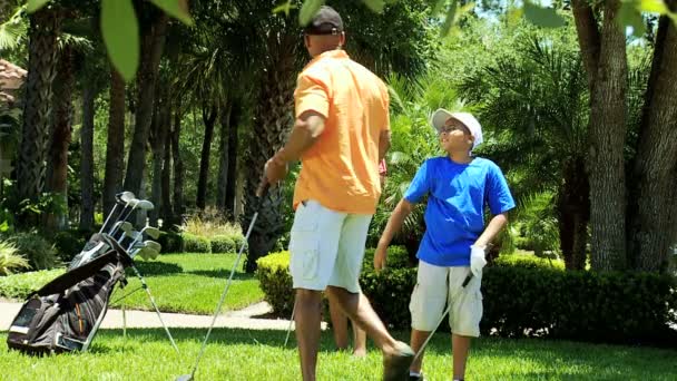 Padres e hijo con palos de golf — Vídeo de stock