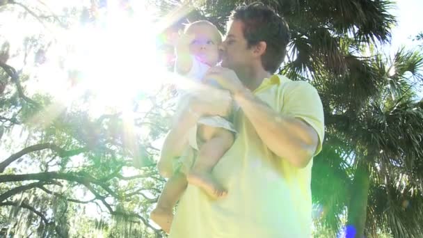 Young Caucasian father enjoying time at outdoors park with toddler son — Stock Video