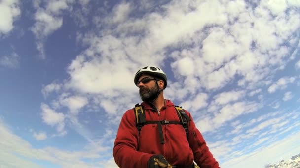 Peak Climber filming the mountain landscape with  snow caped Peaks — Stock Video