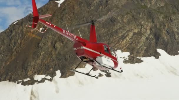 Helicopter taking off in snow covered wilderness — Stock Video