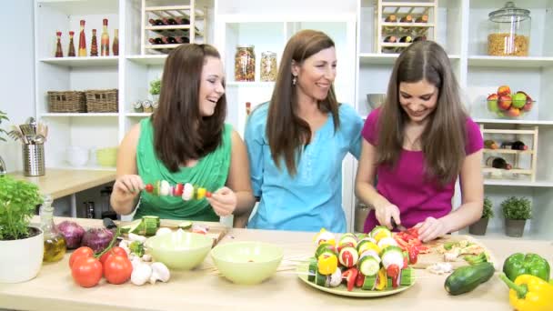 Mom helping her teenage daughters at home kitchen — Stock Video