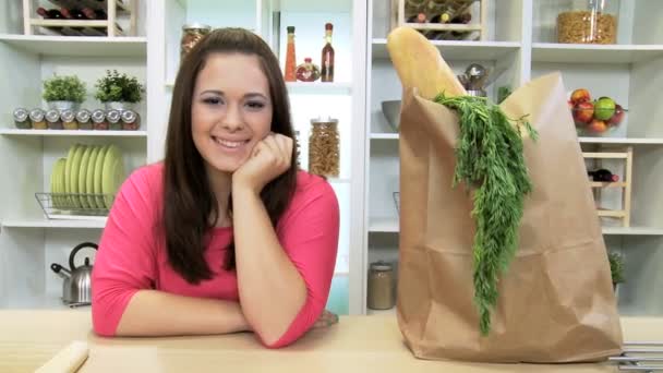 Teenage Caucasian female returned from shopping with large paper bag — Stock Video