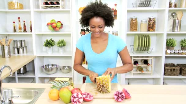 Female at kitchen cutting pineapple — Stock Video