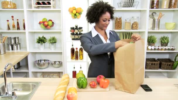 Businesswoman at kitchen unpacking bag — Stock Video