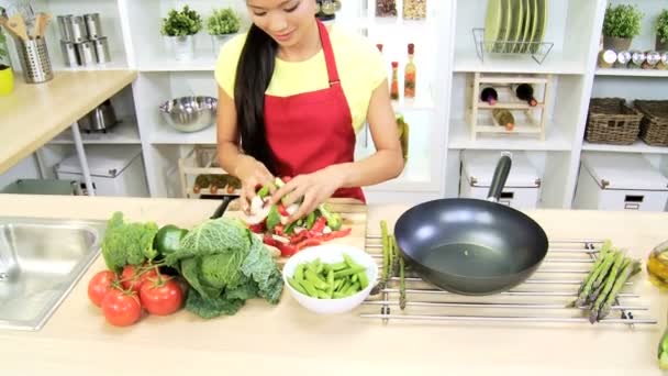 Chica en la cocina preparando verduras — Vídeo de stock