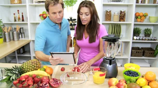 Couple looking recipe on tablet — Stock Video