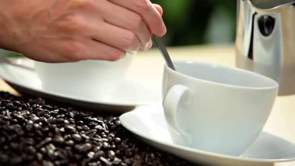 Hands pouring milk into coffee — Stock Video