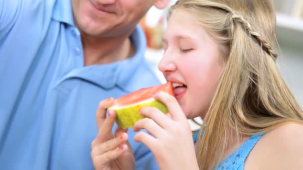 Father and daughter eating watermelon — Stock Video