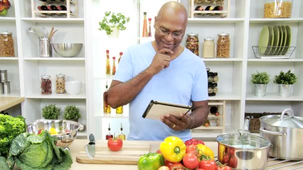 Man in the kitchen preparing with tablet — Stock Video