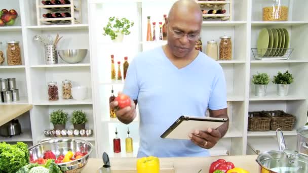 Man in the kitchen preparing with tablet — Stock Video