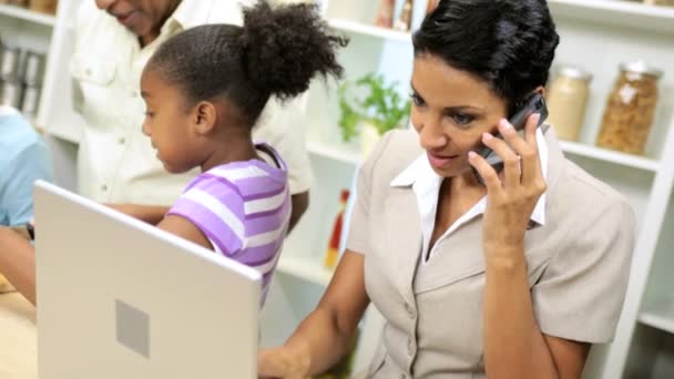 Affärskvinna, arbete och talar i en mobiltelefon när familjen kockar i köket — Stockvideo