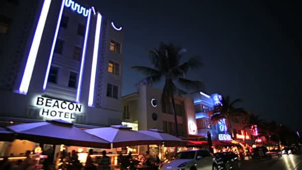 Night driving across illuminated restaurants — Stock Video