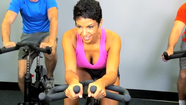 Gym members on exercise bikes — Stock Video