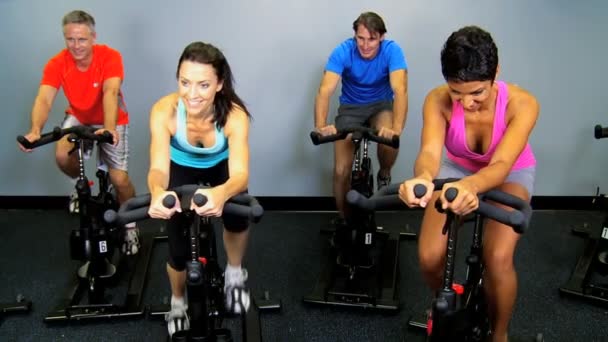 Gym members on exercise bikes — Stock Video