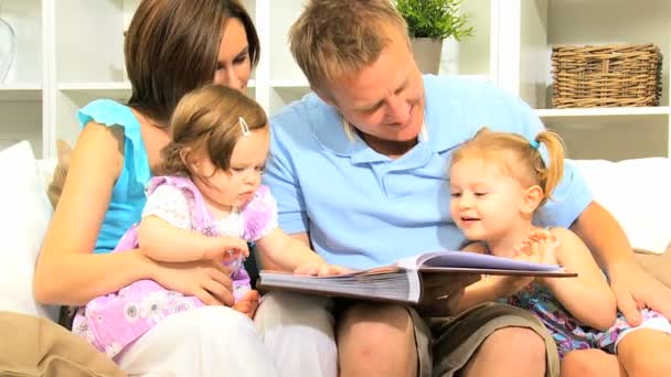 Young Parents Daughters with Photo Album — Stock Video