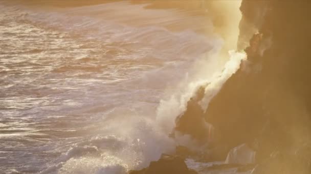 Steam from boiling lava flows beside jagged coastal rocks — Stock Video