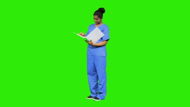 Nursing assistant consulting patient records — Stock Video