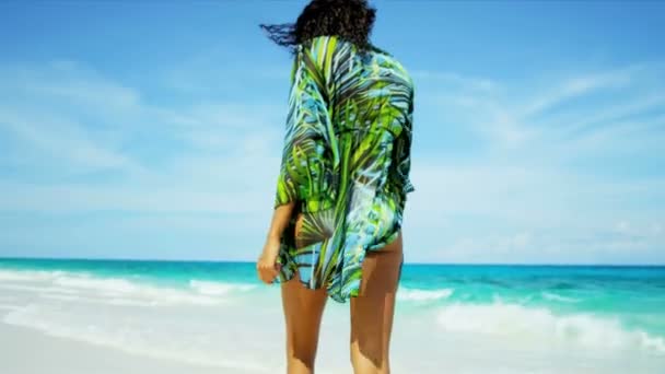 Латиноамериканського дівчина, йдучи поруч з океану мілководді тропічний пляж — стокове відео