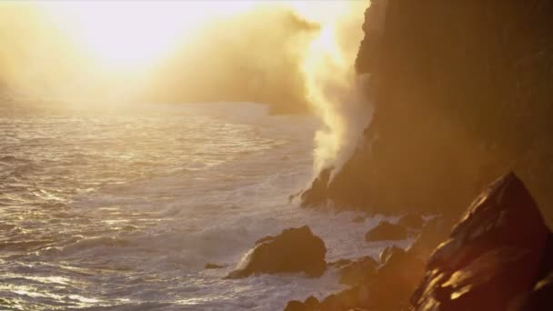 Steam from boiling lava flows beside jagged coastal rocks — Stock Video