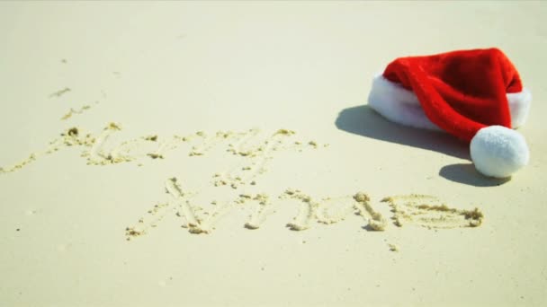 Seasonal Greeting Sand Beside Santa Hat — Stock Video