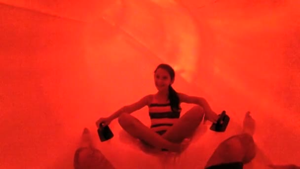 Girl sliding down plastic chute — Stock Video