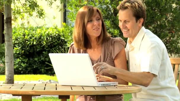 Couple at home garden with laptop computer — Stock Video