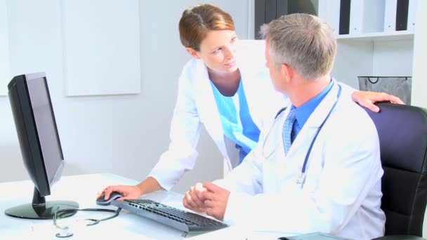 Médicos usando computadora en consultorio médico — Vídeo de stock