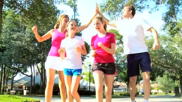 Parents with young teenage daughters jogging — Stock Video