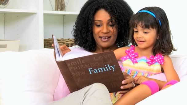 Mother with her daughter looking photo album — Stock Video