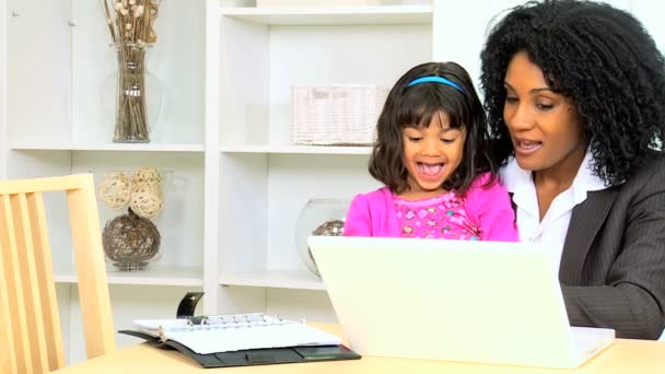 Business woman working at home with her daughter — стоковое видео