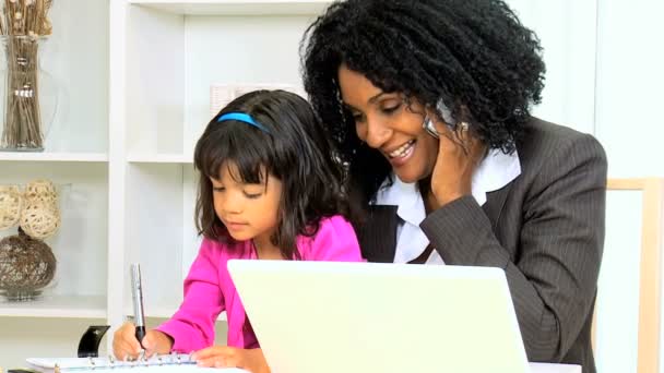 Woman working at home with her daughter — Stock Video