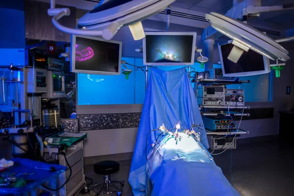 Intensive care unit in hospital medical operating theatre room with equipment and video camera technology supporting laparoscopy keyhole surgery