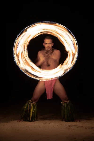 Polynesian male Fire dancers performing with spinning flaming torches a traditional dance culture in tropical French Polynesia South Pacific travel