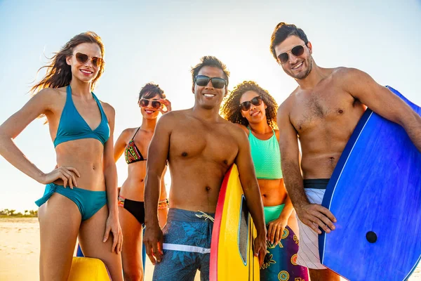 Group Portrait Smiling Multi Ethnic Friends Swimwear Sunglasses Going Bodyboarding — ストック写真