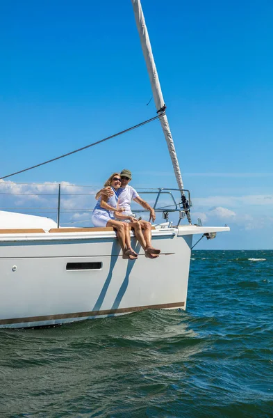 Senior American couple loving life in retirement relaxing on vacation sailing luxury yacht on travel adventure across ocean