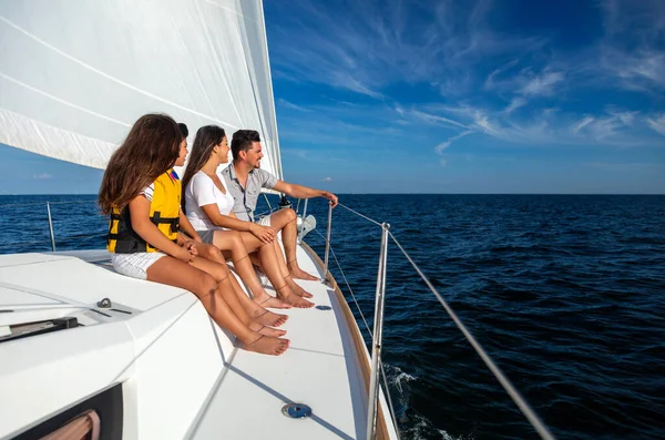 Latin American parents with son and daughter in lifejackets enjoying outdoor living traveling the ocean on luxury yacht