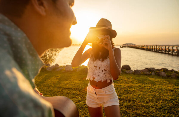 Young Ethnic Couple Vacation Relaxing Ocean Sunset Playing Guitar Taking Stock Image