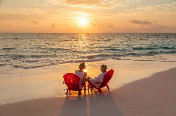 Senior Caucasian American Couple Carefree Lifestyle Relaxing Red Chairs Ocean Stock Image