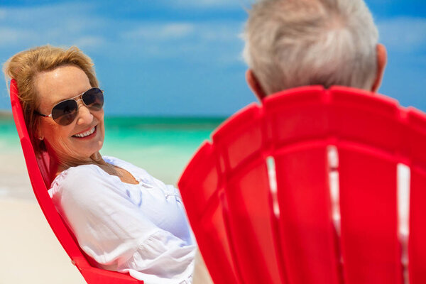 Smiling Senior Female Sunglasses Caucasian Male Sitting Relaxed Red Chairs Royalty Free Stock Images