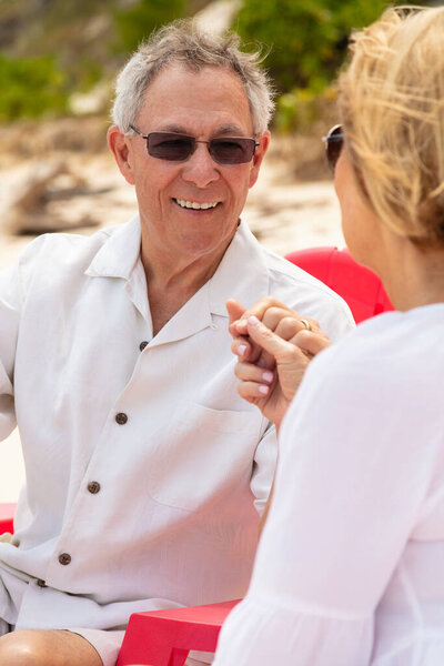 Smiling Senior Caucasian Male Wearing Sunglasses Holding Hands Female Beach Stock Photo