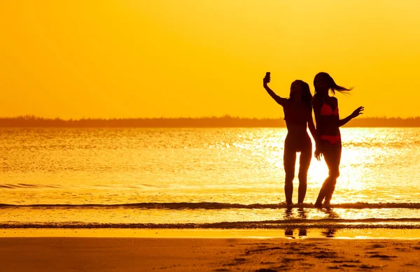 Silueta Chicas Traje Baño Divirtiéndose Vacaciones Verano Amanecer Tomando Selfie —  Fotos de Stock